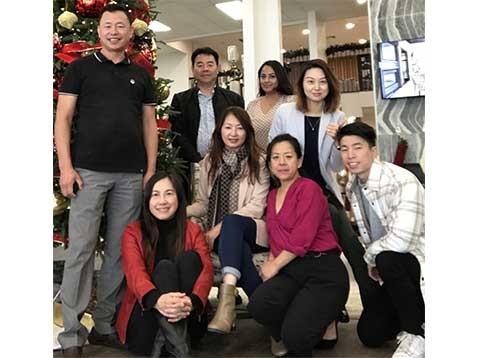 Dealership staff grouped together posing for a photo